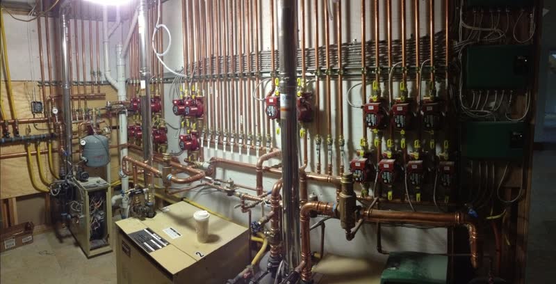 Boiler room with a wall of circulator pumps serviced by Community II