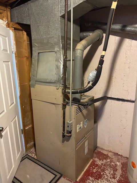 Gas furnace installed in a Staten Island utility closet